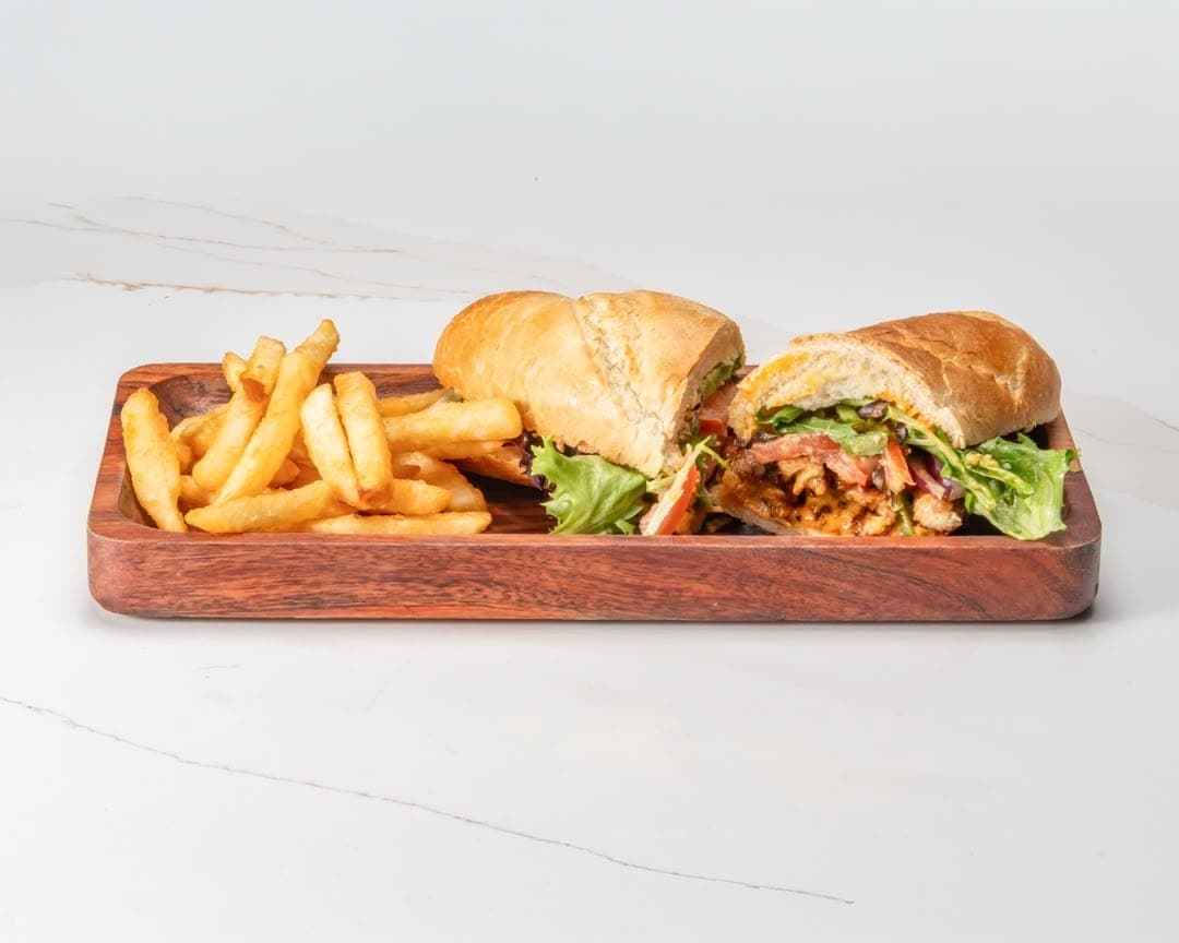 Grilled chicken sandwich served with french fries